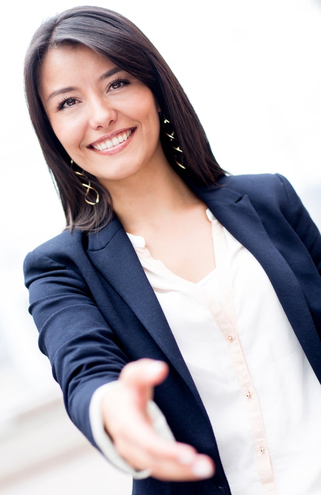 Business woman with hand extended to handshake